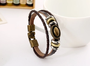 Detail of vintage multilayer braided leather bracelet wrapped around a ceramic mug
