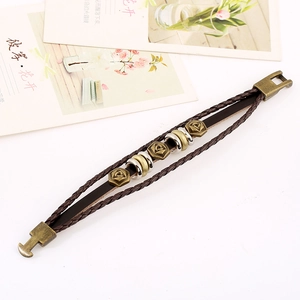 Retro multi-layer woven leather bracelet featuring bronze rose metal charms on white background
