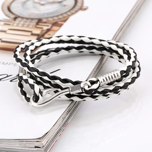 Close-up of braided multilayer leather nautical bracelet with silver fish hook clasp