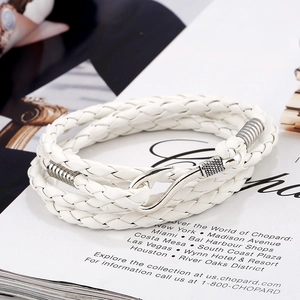 Detailed shot of a multi-layer white braided leather bracelet with a silver fishhook clasp