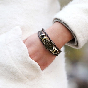 Vintage multi-layer braided leather bracelet with coin pendant and metal rings detail