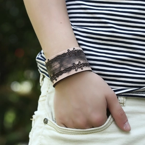 Men's punk style wide leather bracelet with vintage barbed wire pattern in brown