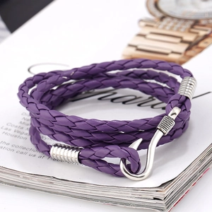 Close-up of a purple multi-layer braided leather bracelet with a silver fish hook clasp