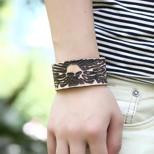 Vintage wide leather skull bracelet with fire totem engraving for men worn on wrist