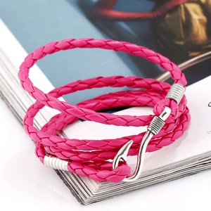 Macro shot of pink braided multi-layer leather bracelet with silver fish hook buckle clasp