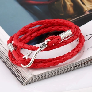 Macro detail of red multilayer braided leather bracelet with silver fish hook clasp