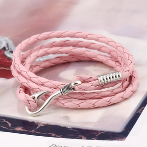 Macro detail of pink braided PU leather wrap bracelet with silver fish hook clasp
