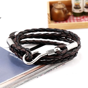 Close-up of nautical multi-layer braided leather bracelet with silver fish hook clasp