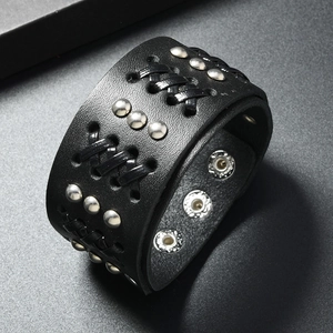 Detail of punk leather wide bracelet featuring silver rivets and adjustable snap buttons