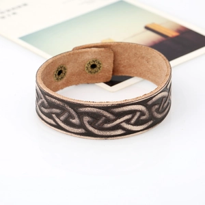 Vintage brown leather bracelet with embossed Celtic knot and adjustable metal snap buttons