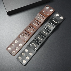 Detailed close-up of punk leather bracelets with metal rivets and woven texture