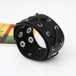 Punk style wide black leather bracelet with silver eyelets and adjustable snap buttons