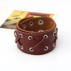 Punk style wide reddish brown leather bracelet with eyelets and cross laces on white background