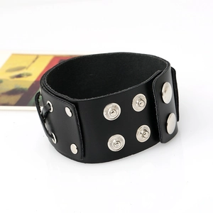 Detail view of black punk leather bracelet with silver studs and braided side cords
