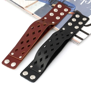Detail of black and brown multi-layer leather bracelets with silver metal snaps