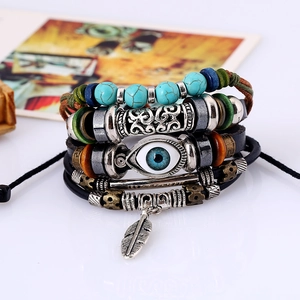 Multilayer leather bracelet with evil eye bead and feather pendant on white background