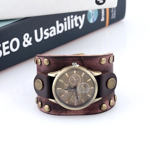 Macro detail of retro punk brown leather watch band with brass rivets and snap buttons