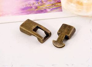 Macro detail of vintage bronze metal buckle clasps for DIY jewelry and bag hardware