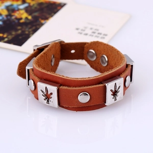 Vintage brown leather wristband with silver maple leaf studs and snap closure