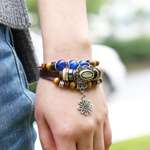 Men's retro multilayer leather beaded bracelet with silver daisy charm on wrist