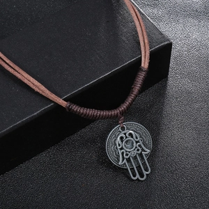 Vintage Hamsa Hand pendant on braided brown leather cord with engraved metal disk