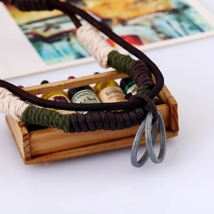 Retro brown woven leather necklace for men featuring vintage metal rings and thread details