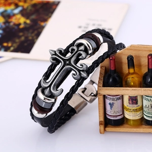 Retro woven black leather bracelet featuring a vintage silver gothic cross pendant