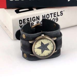 Detail view of vintage punk leather cuff watch with bronze rivets and star dial pattern