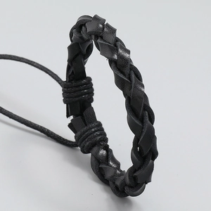 Minimalist black braided leather bracelet featuring adjustable drawstring and handmade cord