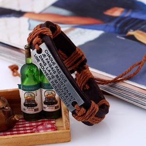 Handmade vintage leather bracelet with engraved French quote on aged metal plate