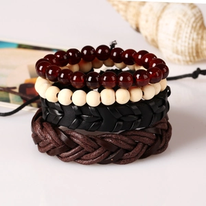Detail of four-piece woven leather bracelet set with wooden beads and starfish props
