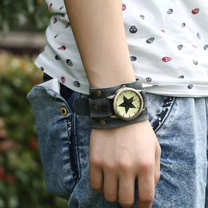 Vintage punk men's watch with wide grey leather strap and black star dial on wrist