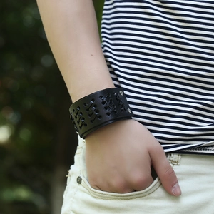 Retro multi-layer woven black leather bracelet with silver studs shown on a male wrist