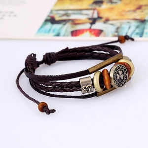 Detail of Irish clover charm and Ireland engraving on multi-layer leather bracelet