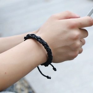 Minimalist black braided leather bracelet with adjustable drawstring closure for men and women