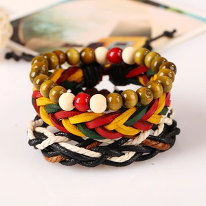Detail of Jamaican style braided leather and wooden bead bracelets in red yellow and green