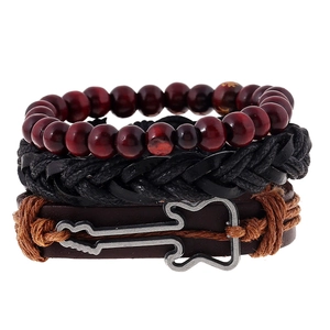 Macro detail of multi-layer leather bracelet with guitar charm and wooden beads