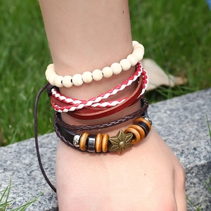 Bohemian multi-layer leather bracelet set with bronze star pendant on a female wrist