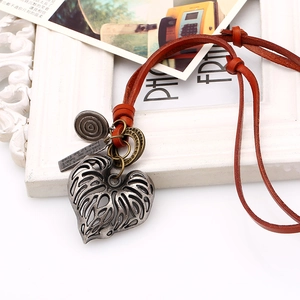 Vintage leather cord necklace featuring an antique silver heart pendant and metal charms