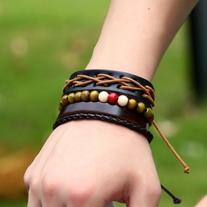 Multilayer leather bracelet set with woven ropes and wooden beads on a model's wrist