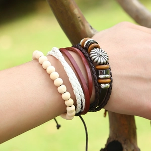 Multilayer leather bracelet set with sunflower metal charm and wooden beads on model