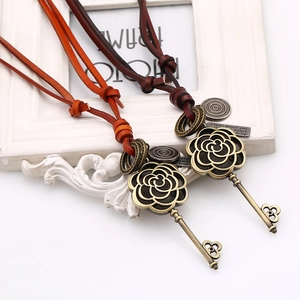 Detail of vintage key necklaces with genuine leather cords in bronze floral design
