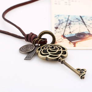 Vintage long leather cord necklace with bronze hollow rose key and engraved metal pendants