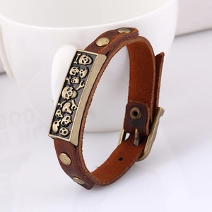 Vintage brown leather bracelet with bronze skull plaque and adjustable buckle closure