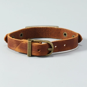 Detail of vintage brown leather bracelet with bronze buckle and matte texture finish