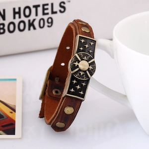 Vintage brown leather bracelet featuring antique bronze rivets and star compass metal plate