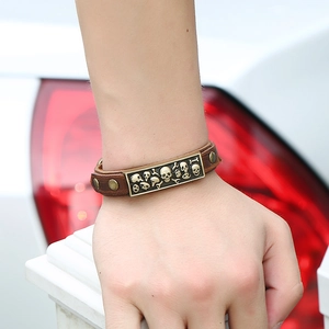Vintage punk skull cowhide leather bracelet with bronze metal studs on wrist