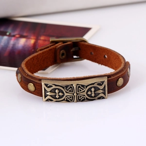 Retro brown leather bracelet featuring an embossed gothic cross alloy plate and rivet details