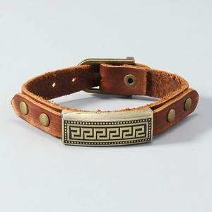 Detail of brown leather multi-layer bracelet with bronze Greek key pattern and buckle
