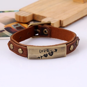 Retro brown leather bracelet with Love arrow metal plate and bronze rivets on wood base